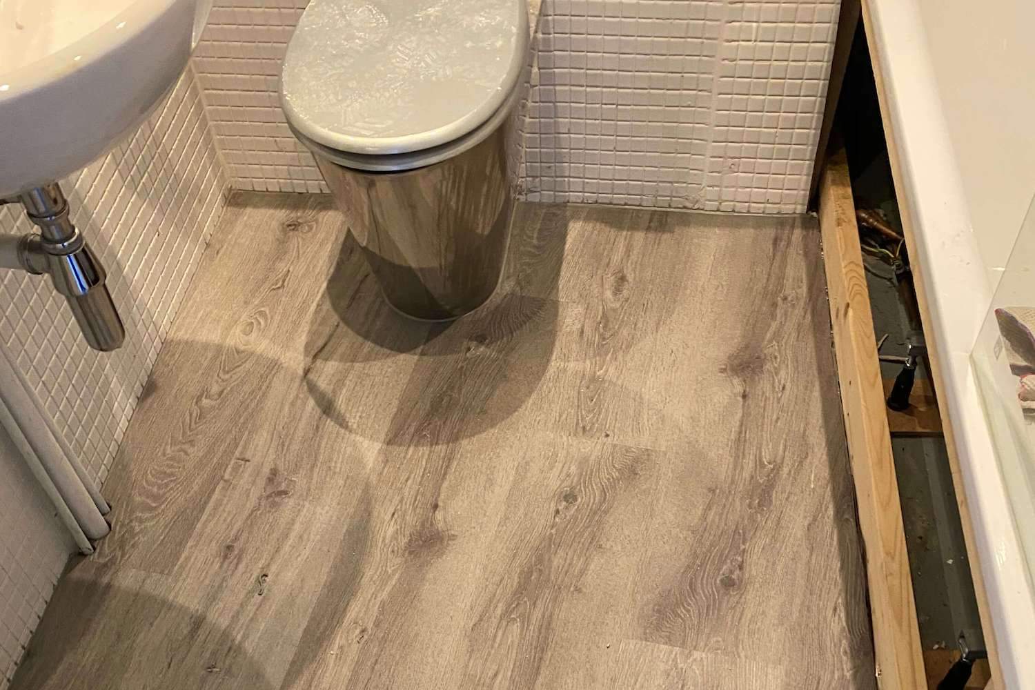 Impervia French Grey Luxury Flooring push fit in a toilet